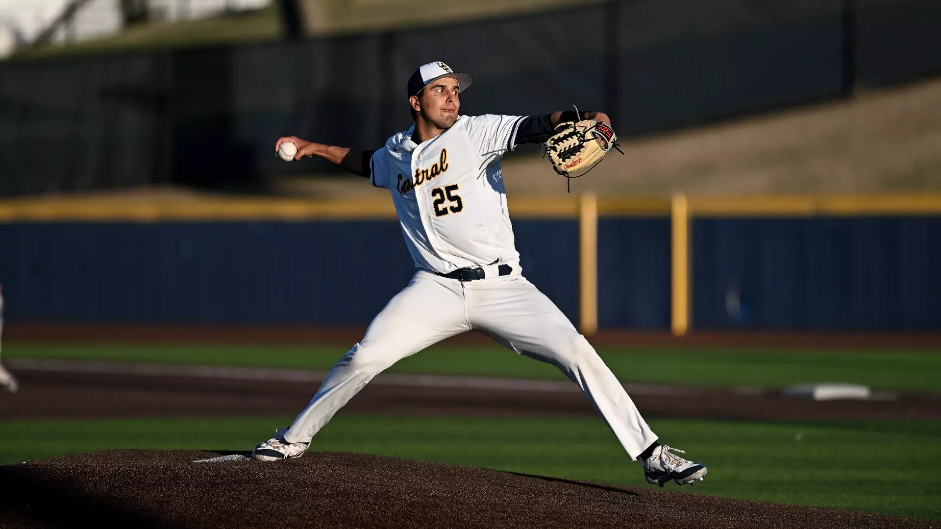 Baseball player winding up to pitch