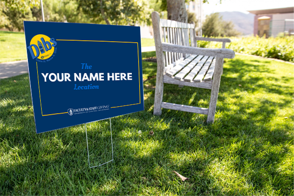 Photo of yard sign near park bench