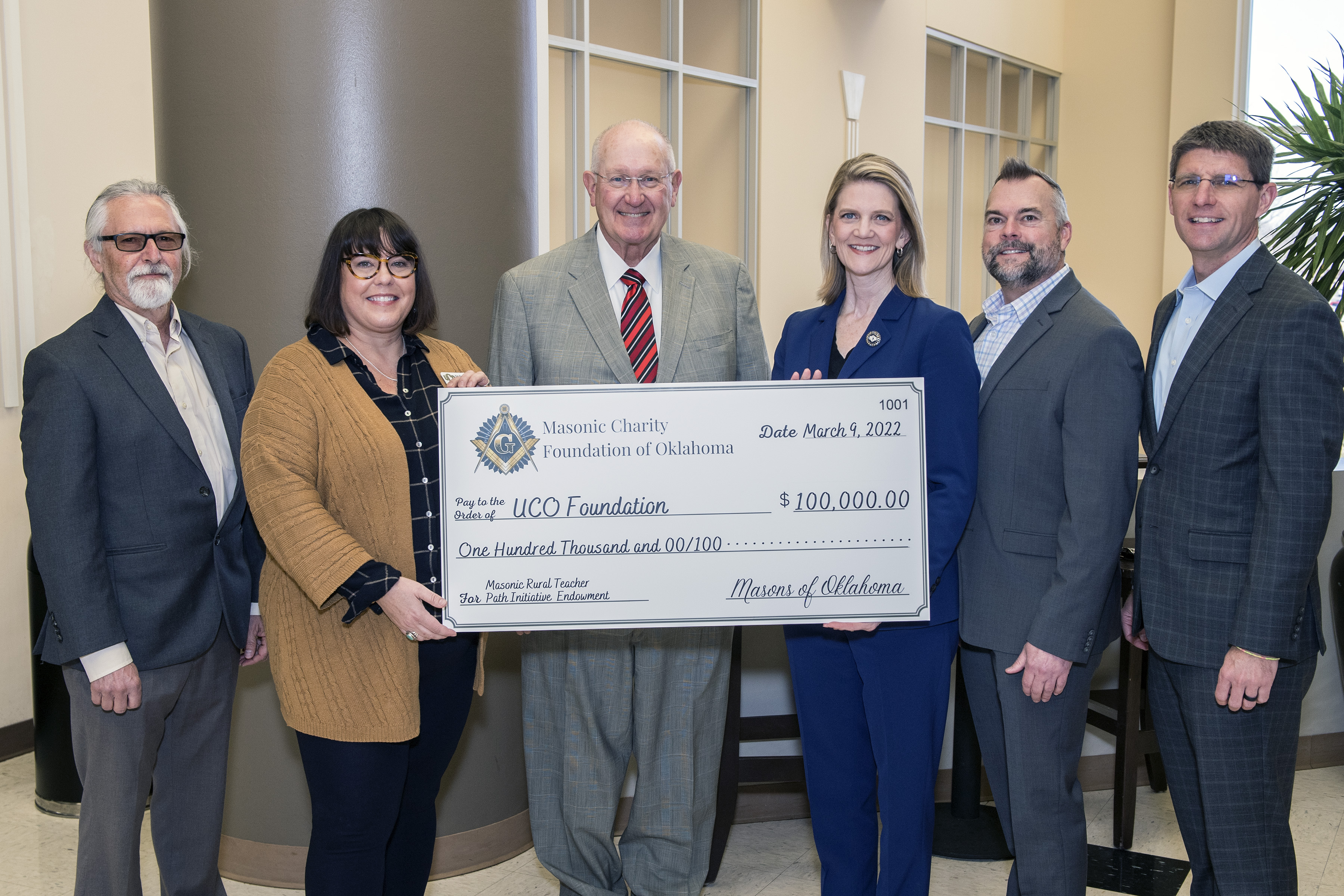 Photo of UCO faculty and staff with Masonic Charity of Oklahoma executive director and President Neuhold-Ravikumar