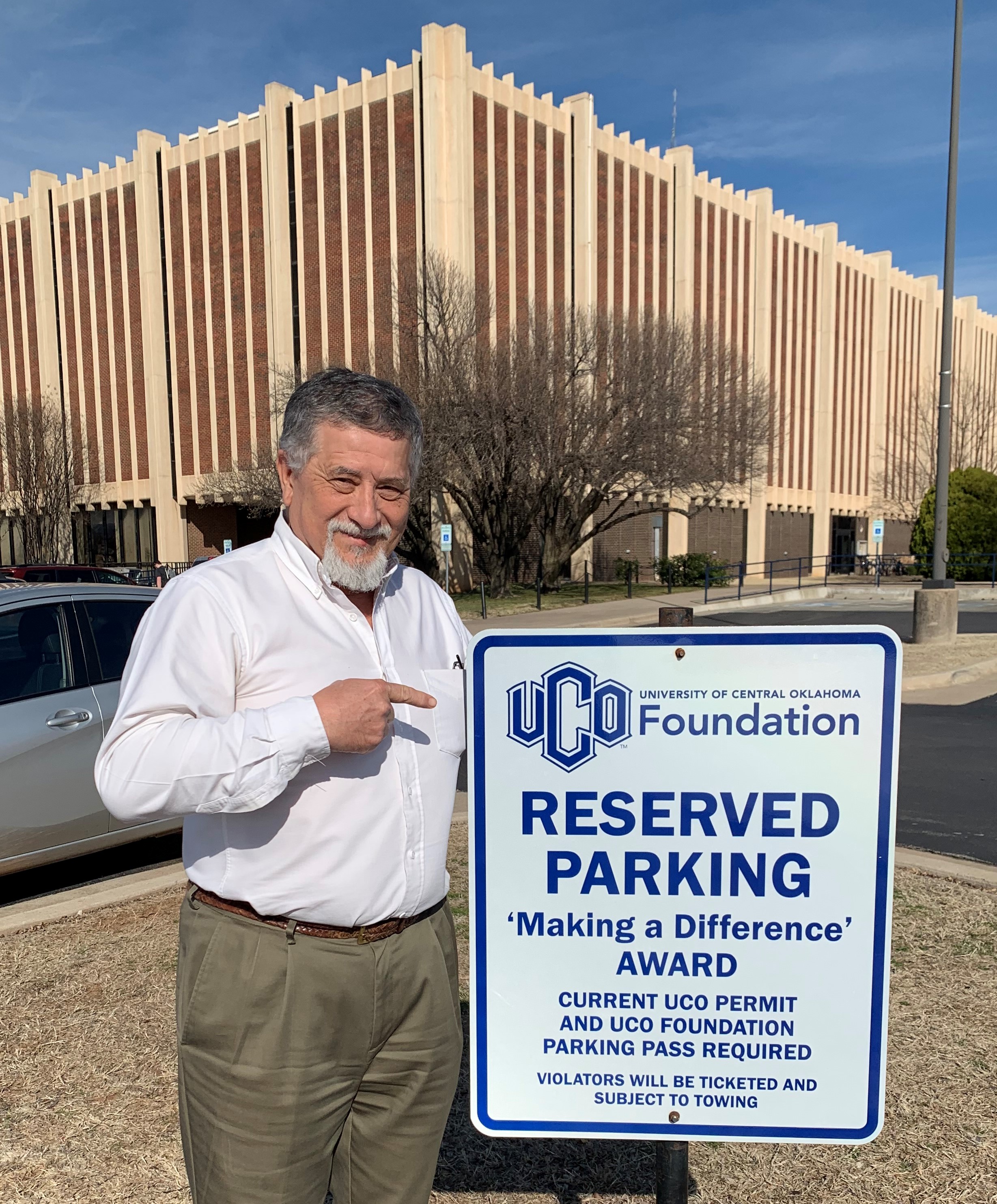 UCO employee Michael Calhoun stands by parking space