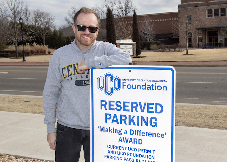 UCO employee Matt Fowler stands by parking space